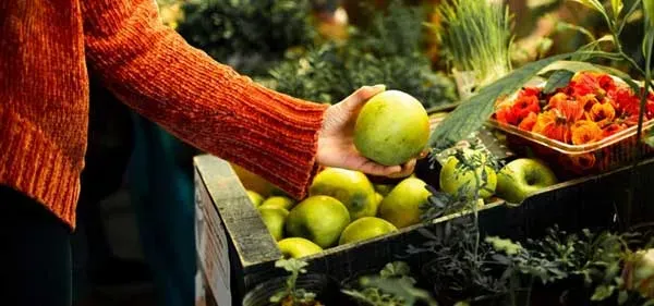 Picture of a woman holding an apple